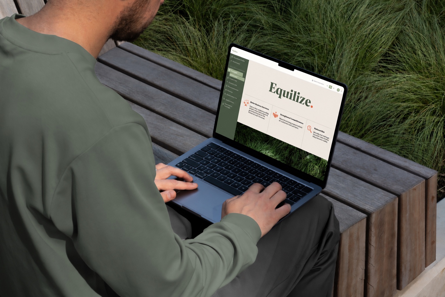 A person working outdoors with Equilize. on their laptop screen.